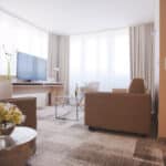 Appartement neu 2022 Blick in den Wohnbereich mit Couch, großen Schreibtisch und TV